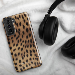 A smartphone with a leopard print, dual-layer design phone case featuring four camera lenses on the back is displayed against a white background. The bottom of the tough phone case has the brand name "Statement Cases" in white letters. The product name is "Daring Cheetah Fur for Samsung".