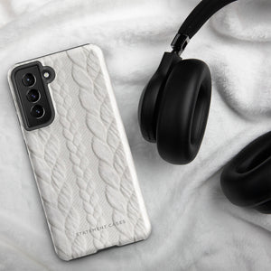 A stylish, impact-resistant phone case with a textured white braided design, covering the back of a smartphone. The dual-layer design features cutouts for the camera and buttons, and "Cozy Knit Bliss for Samsung" by Statement Cases is embossed at the bottom.