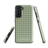 A smartphone with a green and white houndstooth patterned impact-resistant case is shown. The phone's camera module with multiple lenses is visible on the top left corner of the Elegance Houndstooth for Samsung shock-absorbing case by Statement Cases.