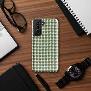 A smartphone with a green and white houndstooth patterned impact-resistant case is shown. The phone's camera module with multiple lenses is visible on the top left corner of the Elegance Houndstooth for Samsung shock-absorbing case by Statement Cases.