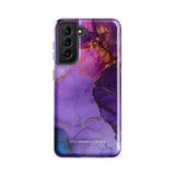 The Golden Orchid Marble for Samsung by Statement Cases is a smartphone adorned with a vibrant, abstract phone case showcasing a mix of purple, pink, and gold colors. Crafted from impact-resistant materials, it features a camera module with four lenses and a flash. At the bottom of the shock-absorbing phone case, you’ll find the text "STATEMENT CASES" in white.