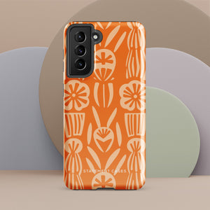 This stylish smartphone accessory, the Savannah Ardiente for Samsung by Statement Cases, features a shock-absorbing, colorful patterned case adorned with abstract flower designs in beige on an orange background. This impact-resistant phone case wraps around the back of your device, providing robust protection for its multiple camera lenses in the corner.