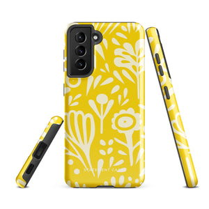 The Sol Dorado for Samsung by Statement Cases is a durable phone case featuring a bright yellow background adorned with an abstract white floral pattern, showcasing various flowers and leaves. Near the bottom edge, the text "STATEMENT CASE" highlights its dual-layer design for enhanced durability.