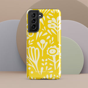 The Sol Dorado for Samsung by Statement Cases is a durable phone case featuring a bright yellow background adorned with an abstract white floral pattern, showcasing various flowers and leaves. Near the bottom edge, the text "STATEMENT CASE" highlights its dual-layer design for enhanced durability.