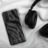 A tough smartphone with a black, textured case that has a silky, animal fur pattern. The dual-layer phone case has cutouts for the camera and side buttons, and the words "Statement Cases" are printed near the bottom.