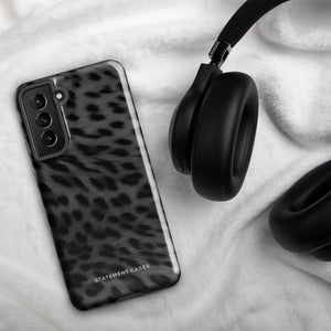 A Nocturnal Hunter Fur for Samsung with a black and gray leopard print phone case featuring a dual-layer design. The camera module has five lenses and a flash. The text "STATEMENT CASES" is written at the bottom of this impact-resistant case.