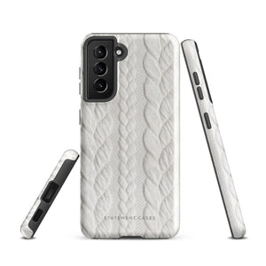 A stylish, impact-resistant phone case with a textured white braided design, covering the back of a smartphone. The dual-layer design features cutouts for the camera and buttons, and "Cozy Knit Bliss for Samsung" by Statement Cases is embossed at the bottom.