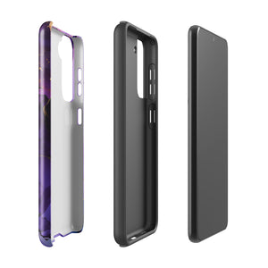 The Golden Orchid Marble for Samsung by Statement Cases is a smartphone adorned with a vibrant, abstract phone case showcasing a mix of purple, pink, and gold colors. Crafted from impact-resistant materials, it features a camera module with four lenses and a flash. At the bottom of the shock-absorbing phone case, you’ll find the text "STATEMENT CASES" in white.