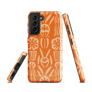 This stylish smartphone accessory, the Savannah Ardiente for Samsung by Statement Cases, features a shock-absorbing, colorful patterned case adorned with abstract flower designs in beige on an orange background. This impact-resistant phone case wraps around the back of your device, providing robust protection for its multiple camera lenses in the corner.