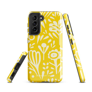 The Sol Dorado for Samsung by Statement Cases is a durable phone case featuring a bright yellow background adorned with an abstract white floral pattern, showcasing various flowers and leaves. Near the bottom edge, the text "STATEMENT CASE" highlights its dual-layer design for enhanced durability.