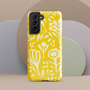 The Sol Dorado for Samsung by Statement Cases is a durable phone case featuring a bright yellow background adorned with an abstract white floral pattern, showcasing various flowers and leaves. Near the bottom edge, the text "STATEMENT CASE" highlights its dual-layer design for enhanced durability.