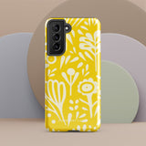 The Sol Dorado for Samsung by Statement Cases is a durable phone case featuring a bright yellow background adorned with an abstract white floral pattern, showcasing various flowers and leaves. Near the bottom edge, the text "STATEMENT CASE" highlights its dual-layer design for enhanced durability.