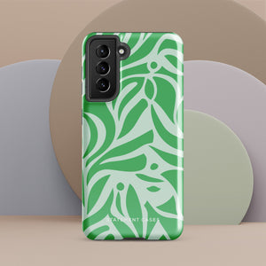 The Selva Verde for Samsung, a product by Statement Cases, is a durable, dual-layer phone case adorned with a green and white leafy design. The back of the case includes a camera cutout, and the bottom is printed with "Statement Cases.