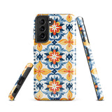 The Mediterranean Bloom for Samsung by Statement Cases features intricate, colorful floral patterns in blue, orange, and yellow. The design covers the entire back of the case, surrounding the camera cutout. Shock-absorbing and impact-resistant, it ensures protection while the brand "Statement Cases" is subtly printed near the bottom.