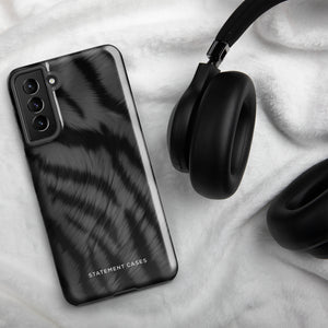 A tough smartphone with a black, textured case that has a silky, animal fur pattern. The dual-layer phone case has cutouts for the camera and side buttons, and the words "Statement Cases" are printed near the bottom.