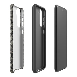 A phone case with a protective dual-layer design featuring an intricate black floral lace pattern. The Omerta Floral for Samsung has four camera cutouts and the brand name "Statement Cases" appears at the bottom center. Impact-resistant and chic, it stands against a plain white background.