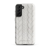 A stylish, impact-resistant phone case with a textured white braided design, covering the back of a smartphone. The dual-layer design features cutouts for the camera and buttons, and "Cozy Knit Bliss for Samsung" by Statement Cases is embossed at the bottom.