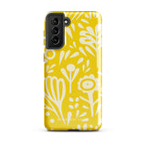 The Sol Dorado for Samsung by Statement Cases is a durable phone case featuring a bright yellow background adorned with an abstract white floral pattern, showcasing various flowers and leaves. Near the bottom edge, the text "STATEMENT CASE" highlights its dual-layer design for enhanced durability.