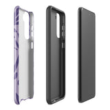 Introducing the Luna Morada for Samsung, a striking smartphone case from Statement Cases. This decorative purple cover boasts abstract floral and organic patterns in darker hues and is designed to absorb shocks. The impact-resistant case features a camera cutout that accommodates five lenses, with the brand name "STATEMENT CASES" elegantly printed at the bottom center.