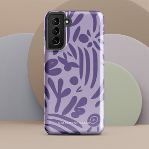 Introducing the Luna Morada for Samsung, a striking smartphone case from Statement Cases. This decorative purple cover boasts abstract floral and organic patterns in darker hues and is designed to absorb shocks. The impact-resistant case features a camera cutout that accommodates five lenses, with the brand name "STATEMENT CASES" elegantly printed at the bottom center.