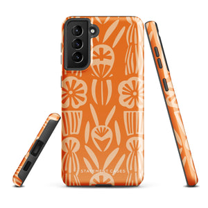 This stylish smartphone accessory, the Savannah Ardiente for Samsung by Statement Cases, features a shock-absorbing, colorful patterned case adorned with abstract flower designs in beige on an orange background. This impact-resistant phone case wraps around the back of your device, providing robust protection for its multiple camera lenses in the corner.