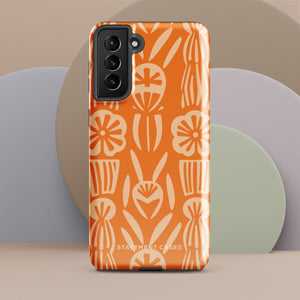 This stylish smartphone accessory, the Savannah Ardiente for Samsung by Statement Cases, features a shock-absorbing, colorful patterned case adorned with abstract flower designs in beige on an orange background. This impact-resistant phone case wraps around the back of your device, providing robust protection for its multiple camera lenses in the corner.