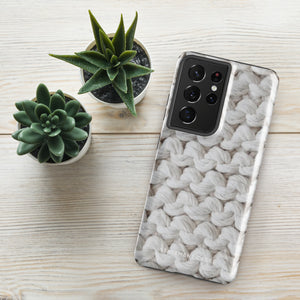 A Chunky Comfort for Samsung with a realistic knitted texture featuring white interwoven yarns. The impact-resistant case has multiple camera cutouts and a shock-absorbing dual-layer design. The brand name "Statement Cases" is printed at the bottom.