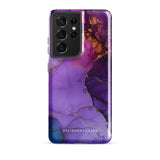 The Golden Orchid Marble for Samsung by Statement Cases is a smartphone adorned with a vibrant, abstract phone case showcasing a mix of purple, pink, and gold colors. Crafted from impact-resistant materials, it features a camera module with four lenses and a flash. At the bottom of the shock-absorbing phone case, you’ll find the text "STATEMENT CASES" in white.