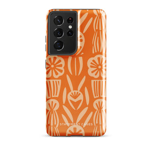 This stylish smartphone accessory, the Savannah Ardiente for Samsung by Statement Cases, features a shock-absorbing, colorful patterned case adorned with abstract flower designs in beige on an orange background. This impact-resistant phone case wraps around the back of your device, providing robust protection for its multiple camera lenses in the corner.