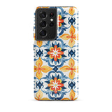 The Mediterranean Bloom for Samsung by Statement Cases features intricate, colorful floral patterns in blue, orange, and yellow. The design covers the entire back of the case, surrounding the camera cutout. Shock-absorbing and impact-resistant, it ensures protection while the brand "Statement Cases" is subtly printed near the bottom.