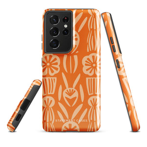 This stylish smartphone accessory, the Savannah Ardiente for Samsung by Statement Cases, features a shock-absorbing, colorful patterned case adorned with abstract flower designs in beige on an orange background. This impact-resistant phone case wraps around the back of your device, providing robust protection for its multiple camera lenses in the corner.