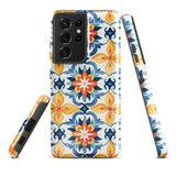 The Mediterranean Bloom for Samsung by Statement Cases features intricate, colorful floral patterns in blue, orange, and yellow. The design covers the entire back of the case, surrounding the camera cutout. Shock-absorbing and impact-resistant, it ensures protection while the brand "Statement Cases" is subtly printed near the bottom.