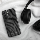 A tough smartphone with a black, textured case that has a silky, animal fur pattern. The dual-layer phone case has cutouts for the camera and side buttons, and the words "Statement Cases" are printed near the bottom.