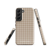 A Samsung smartphone with a beige and brown houndstooth patterned, impact-resistant case from Statement Cases. The phone features multiple cameras on the upper left side of its back. This tough Classic Houndstooth for Samsung phone case has a sleek, dual-layer design with precise cutouts for the cameras and buttons.