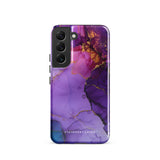 The Golden Orchid Marble for Samsung by Statement Cases is a smartphone adorned with a vibrant, abstract phone case showcasing a mix of purple, pink, and gold colors. Crafted from impact-resistant materials, it features a camera module with four lenses and a flash. At the bottom of the shock-absorbing phone case, you’ll find the text "STATEMENT CASES" in white.