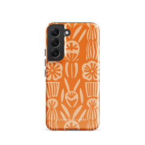 This stylish smartphone accessory, the Savannah Ardiente for Samsung by Statement Cases, features a shock-absorbing, colorful patterned case adorned with abstract flower designs in beige on an orange background. This impact-resistant phone case wraps around the back of your device, providing robust protection for its multiple camera lenses in the corner.