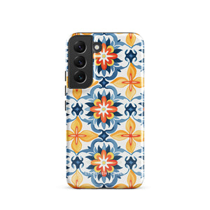 The Mediterranean Bloom for Samsung by Statement Cases features intricate, colorful floral patterns in blue, orange, and yellow. The design covers the entire back of the case, surrounding the camera cutout. Shock-absorbing and impact-resistant, it ensures protection while the brand "Statement Cases" is subtly printed near the bottom.