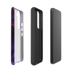 The Golden Orchid Marble for Samsung by Statement Cases is a smartphone adorned with a vibrant, abstract phone case showcasing a mix of purple, pink, and gold colors. Crafted from impact-resistant materials, it features a camera module with four lenses and a flash. At the bottom of the shock-absorbing phone case, you’ll find the text "STATEMENT CASES" in white.