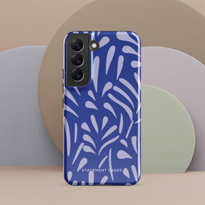 The Mariposa Azul for Samsung smartphone case from Statement Cases is adorned with an impact-resistant design featuring light purple abstract shapes on a blue background. This dual-layer case proudly displays the text "STATEMENT CASES" at the bottom, ensuring that the camera lenses and buttons of your phone remain clearly visible.