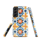 The Mediterranean Bloom for Samsung by Statement Cases features intricate, colorful floral patterns in blue, orange, and yellow. The design covers the entire back of the case, surrounding the camera cutout. Shock-absorbing and impact-resistant, it ensures protection while the brand "Statement Cases" is subtly printed near the bottom.