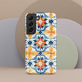 The Mediterranean Bloom for Samsung by Statement Cases features intricate, colorful floral patterns in blue, orange, and yellow. The design covers the entire back of the case, surrounding the camera cutout. Shock-absorbing and impact-resistant, it ensures protection while the brand "Statement Cases" is subtly printed near the bottom.