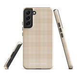 A smartphone with an impact-resistant beige plaid phone case featuring subtle light blue accents. The camera, flash, and sensor modules are visible at the top. The bottom part of the case has the text "Sophisticated Plaid for Samsung" printed on it by Statement Cases.