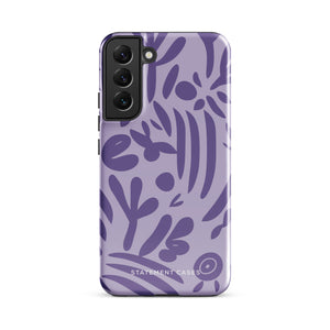 Introducing the Luna Morada for Samsung, a striking smartphone case from Statement Cases. This decorative purple cover boasts abstract floral and organic patterns in darker hues and is designed to absorb shocks. The impact-resistant case features a camera cutout that accommodates five lenses, with the brand name "STATEMENT CASES" elegantly printed at the bottom center.