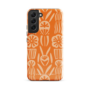 This stylish smartphone accessory, the Savannah Ardiente for Samsung by Statement Cases, features a shock-absorbing, colorful patterned case adorned with abstract flower designs in beige on an orange background. This impact-resistant phone case wraps around the back of your device, providing robust protection for its multiple camera lenses in the corner.