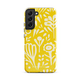 The Sol Dorado for Samsung by Statement Cases is a durable phone case featuring a bright yellow background adorned with an abstract white floral pattern, showcasing various flowers and leaves. Near the bottom edge, the text "STATEMENT CASE" highlights its dual-layer design for enhanced durability.