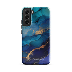 A Samsung smartphone adorned with the Midnight Wave Marble—a vibrant, blue and gold marble-patterned dual-layer phone case. Featuring multiple camera lenses at the top left corner, this impact-resistant case is elegantly labeled "Statement Cases" in white text at the bottom. The design showcases fluid, swirling layers with metallic accents.