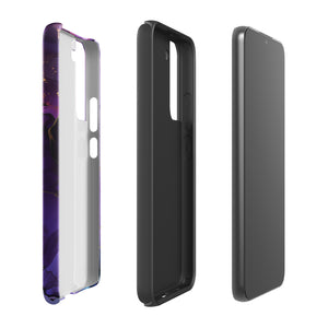 The Golden Orchid Marble for Samsung by Statement Cases is a smartphone adorned with a vibrant, abstract phone case showcasing a mix of purple, pink, and gold colors. Crafted from impact-resistant materials, it features a camera module with four lenses and a flash. At the bottom of the shock-absorbing phone case, you’ll find the text "STATEMENT CASES" in white.