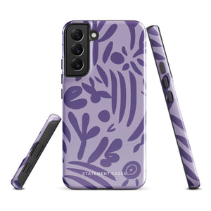 Introducing the Luna Morada for Samsung, a striking smartphone case from Statement Cases. This decorative purple cover boasts abstract floral and organic patterns in darker hues and is designed to absorb shocks. The impact-resistant case features a camera cutout that accommodates five lenses, with the brand name "STATEMENT CASES" elegantly printed at the bottom center.