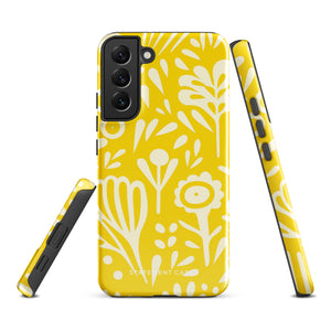 The Sol Dorado for Samsung by Statement Cases is a durable phone case featuring a bright yellow background adorned with an abstract white floral pattern, showcasing various flowers and leaves. Near the bottom edge, the text "STATEMENT CASE" highlights its dual-layer design for enhanced durability.