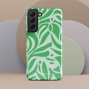 The Selva Verde for Samsung, a product by Statement Cases, is a durable, dual-layer phone case adorned with a green and white leafy design. The back of the case includes a camera cutout, and the bottom is printed with "Statement Cases.